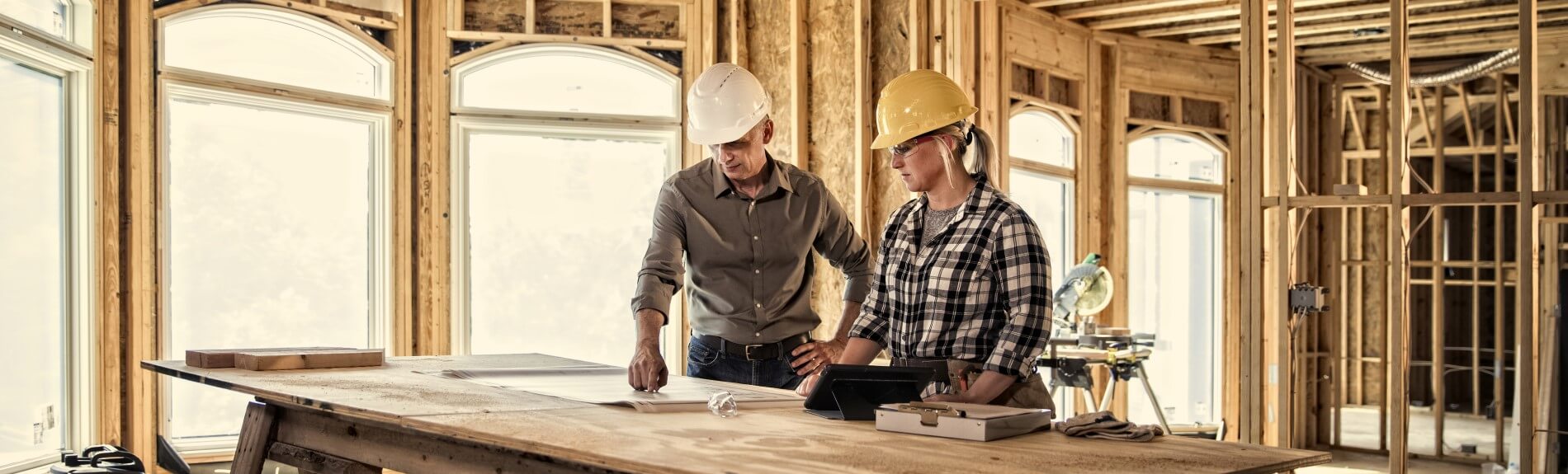 Two construction workers looking at plans