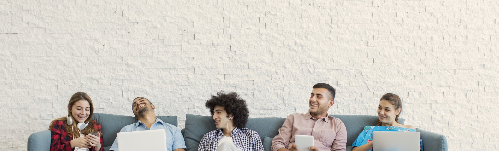 People lounging on couch laughing